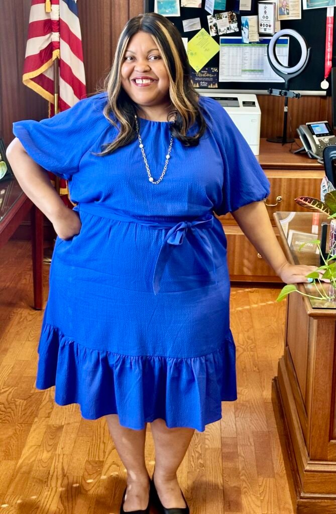 Carmela before, in the office
