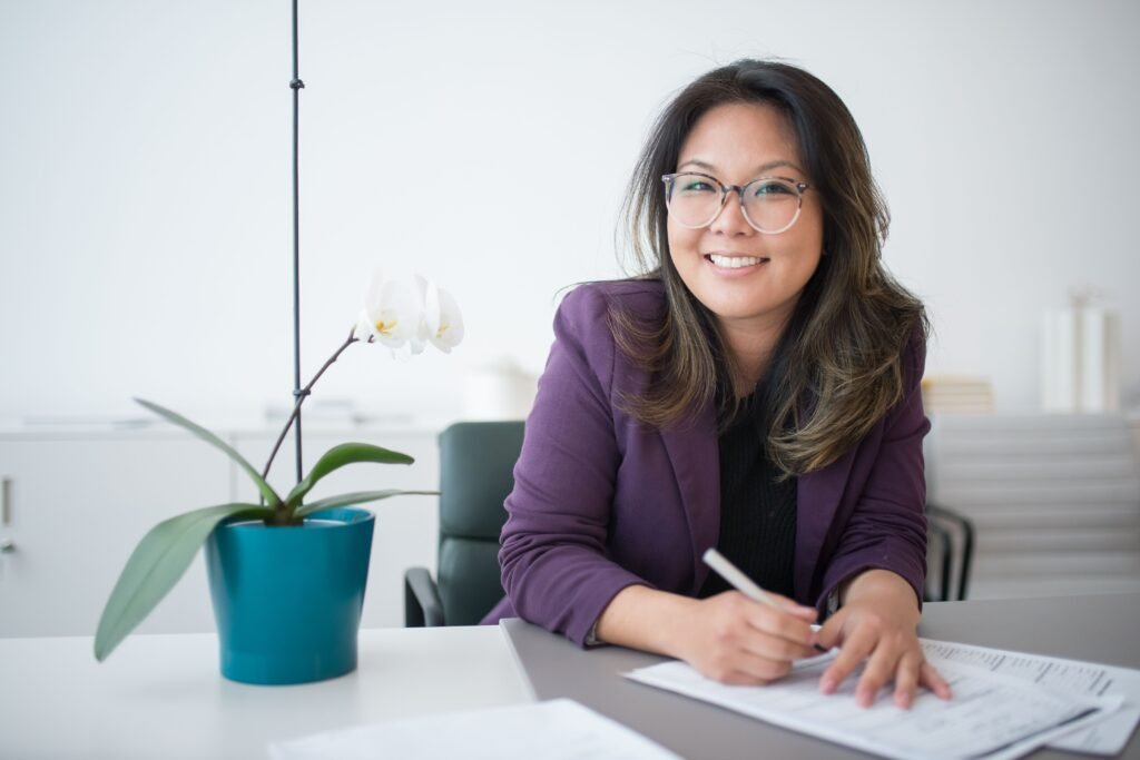 Professional woman writing at her desk — Leadership Affirmation Journal
